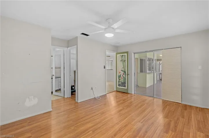Unfurnished bedroom with a ceiling fan, light wood-style flooring, visible vents, and baseboards