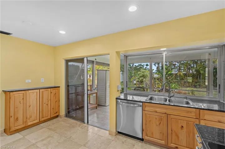 Kitchen with visible vents, dark stone counters, dishwasher, a sink, and recessed lighting