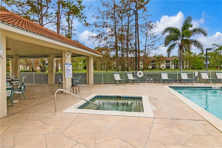 View of pool with a patio area and a community hot tub