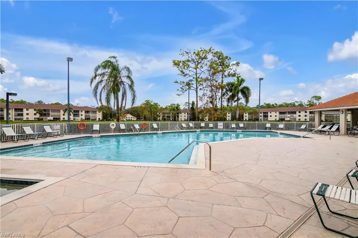 View of main swimming pool featuring a patio