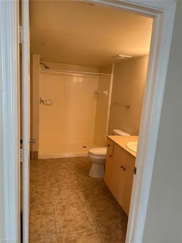 Full bathroom featuring vanity and a shower stall