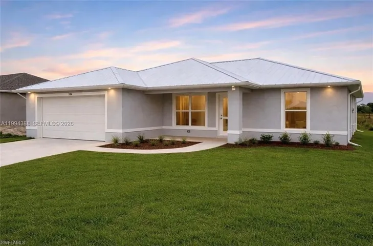 Contemporary single-story residence with a white metal roof and light gray stucco exterior