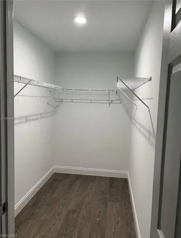 Walk-in closet featuring wire shelving, wood-finish flooring, and a recessed ceiling light