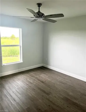 Wood-finish flooring throughout, featuring a clean white baseboard trim