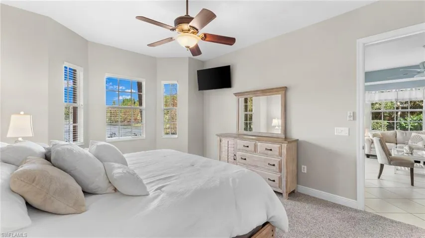 Carpeted bedroom with ceiling fan