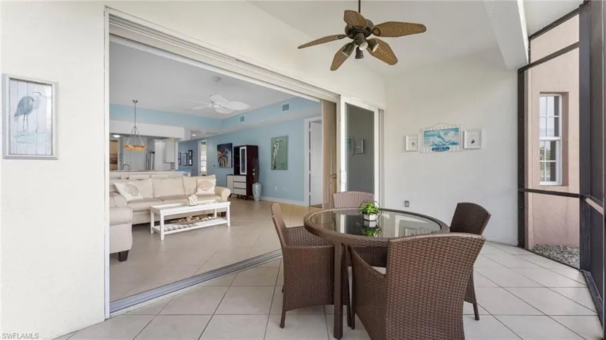 Dining space featuring ceiling fan and light tile patterned floors