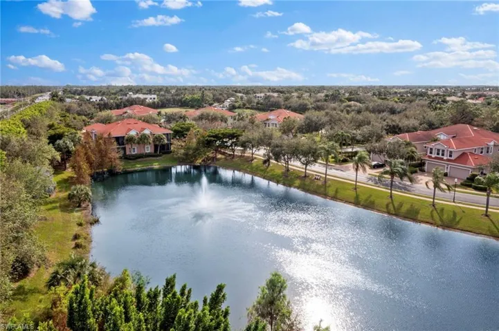 Birds eye view of property with a water view