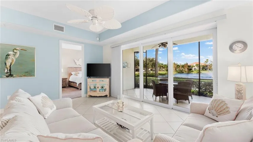 Living room with ceiling fan and light tile patterned floors