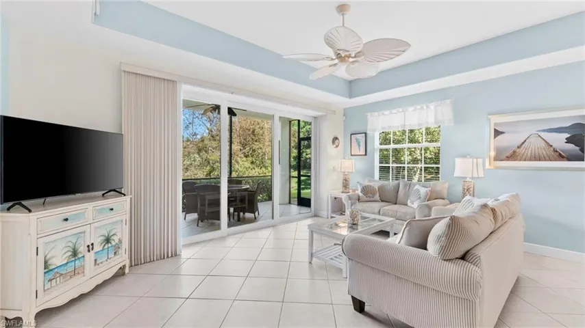 Tiled living room featuring plenty of natural light and ceiling fan