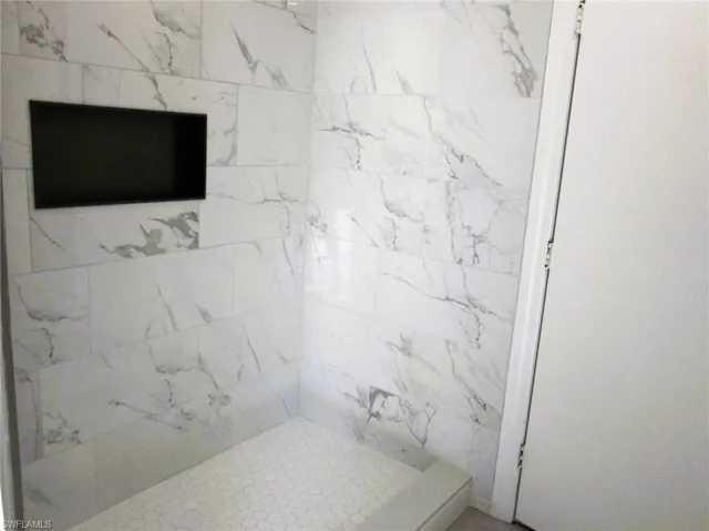 Bathroom with a marble finish shower