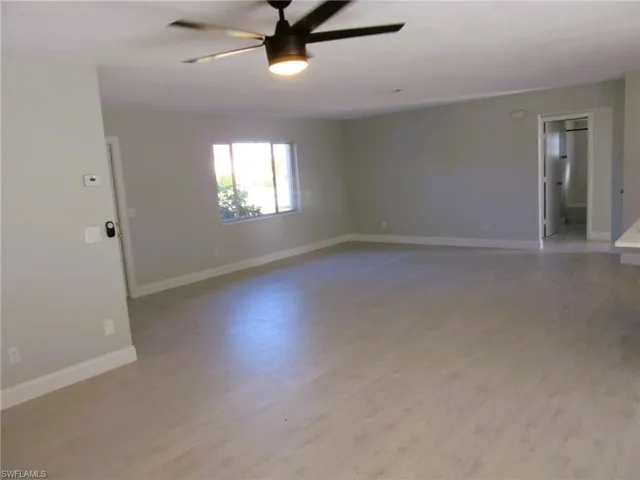 Unfurnished room featuring light wood-type flooring and ceiling fan