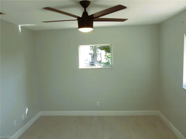 Spare room featuring light wood-style floors and a ceiling fan