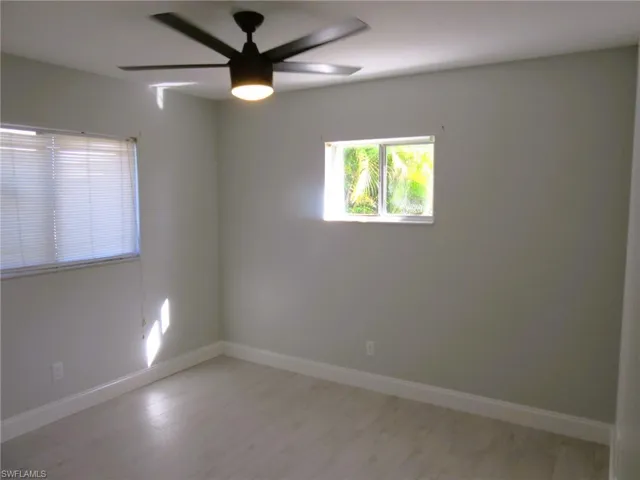 Spare room featuring ceiling fan and light wood finished floors