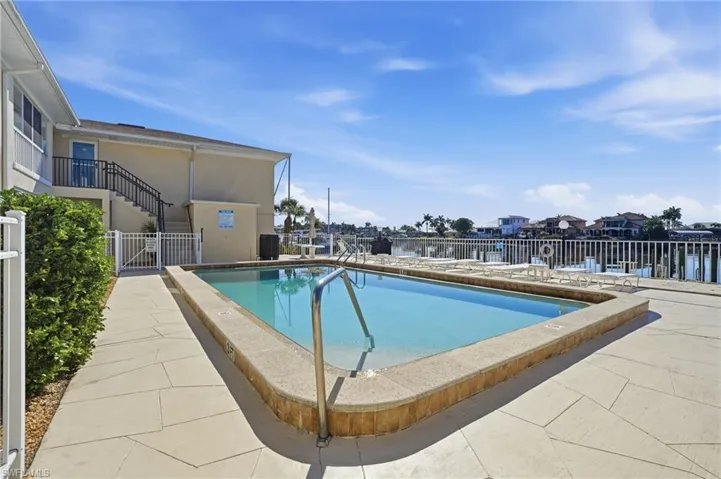 Community pool featuring a patio and a residential view