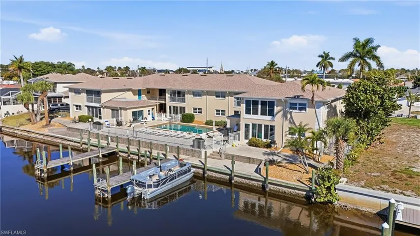 Dock featuring an outdoor pool, a water view, and a patio