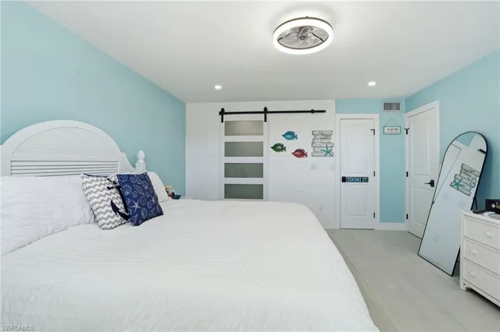 Bedroom featuring a barn door and recessed lighting