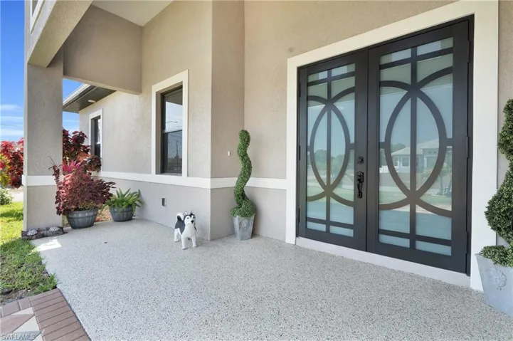 Property entrance with french doors and stucco siding