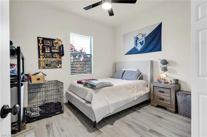 Bedroom with a ceiling fan and wood finished floors