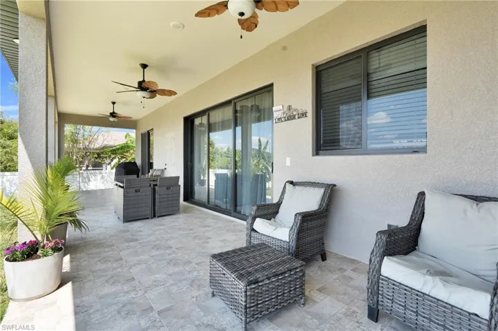 View of patio with a ceiling fan and outdoor dining space
