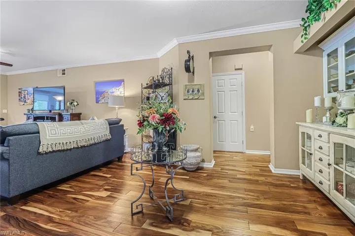Living room with crown molding and hardwood / wood-style floors