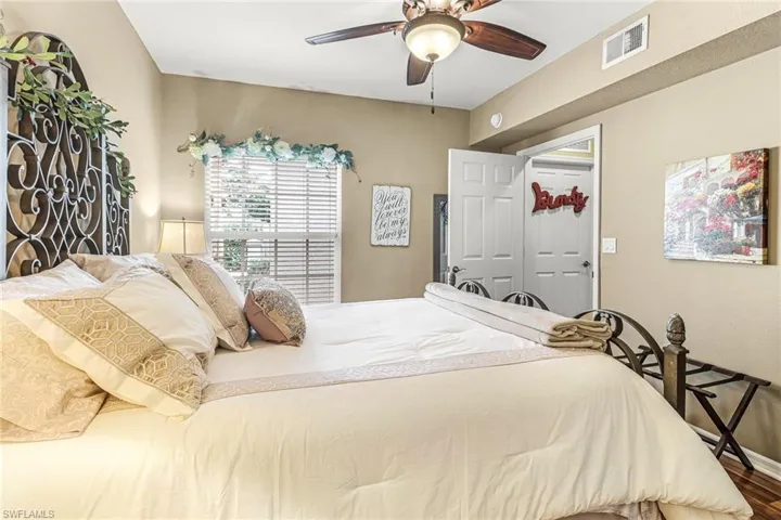 Guest Bedroom featuring wood flooring, a closet, and ceiling fan