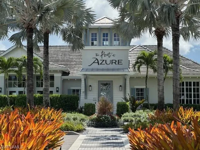 Living room featuring light tile patterned floors, a raised ceiling, a ceiling fan, recessed lighting, and a chandelier