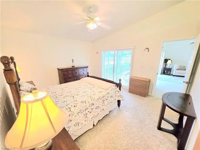 Main Bedroom with lofted ceiling, carpet, and ceiling fan