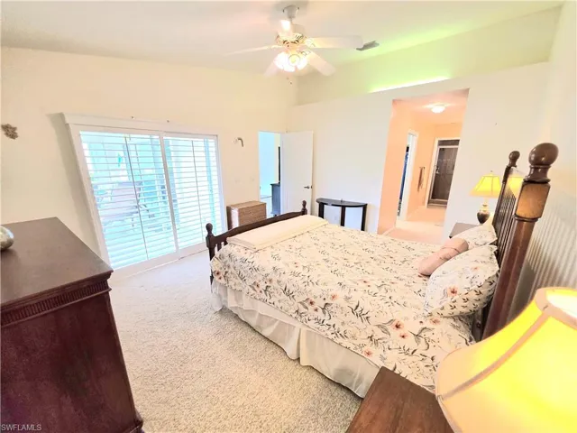 Bedroom featuring light colored carpet, access to outside, and ceiling fan