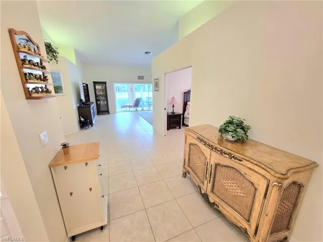 Entry hallway with light tile patterned floors and baseboards