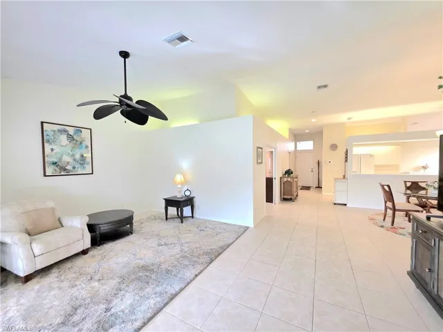 Living area with light tile patterned floors and a ceiling fan