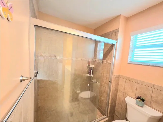 Main Bathroom featuring tile walls