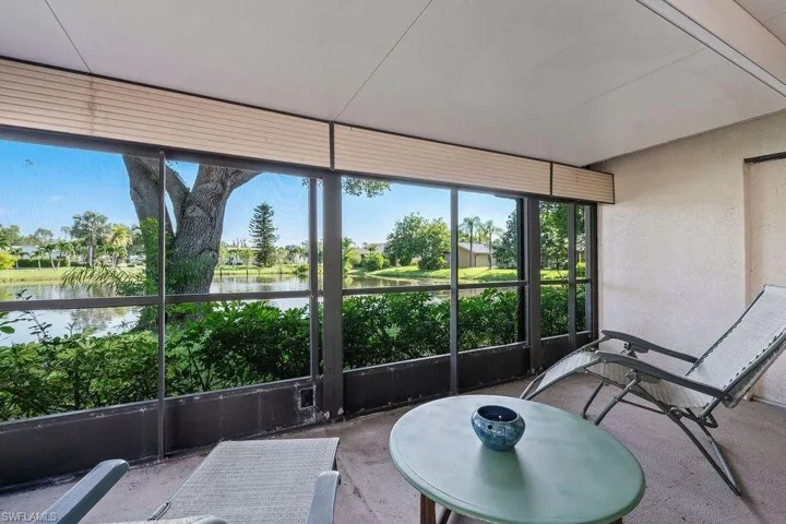 Sunroom / solarium featuring a water view