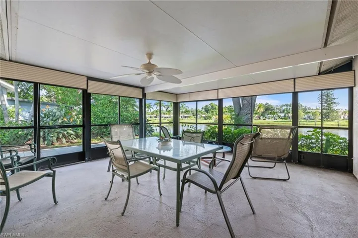 Sunroom / solarium featuring ceiling fan, plenty of natural light, and a water view