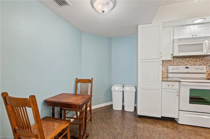 Dining space with dark tile patterned floors