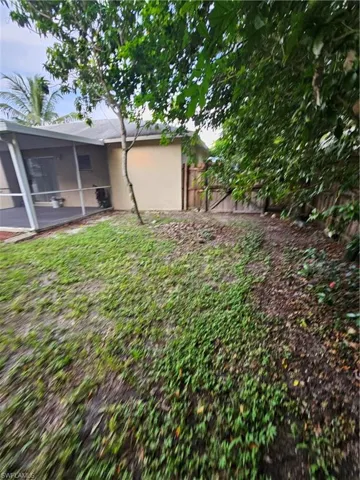 View of yard with a sunroom