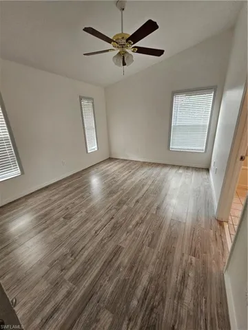 Unfurnished room with ceiling fan and hardwood / wood-style floors