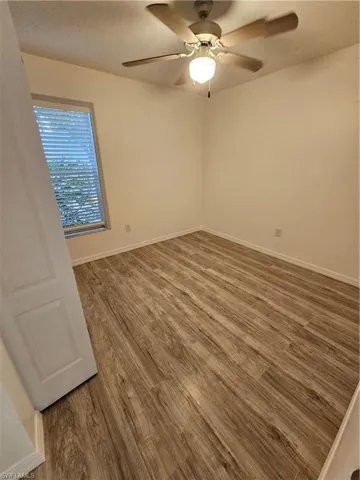 Spare room featuring ceiling fan, hardwood / wood-style flooring, and a textured ceiling