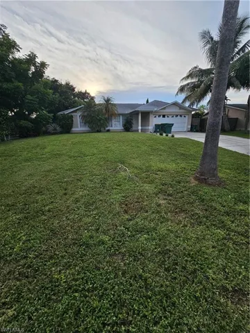 Yard at dusk featuring a garage