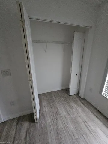 Unfurnished bedroom with light wood-type flooring and a closet