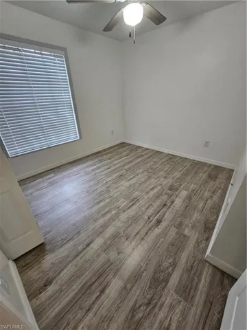 Spare room with ceiling fan and hardwood / wood-style flooring