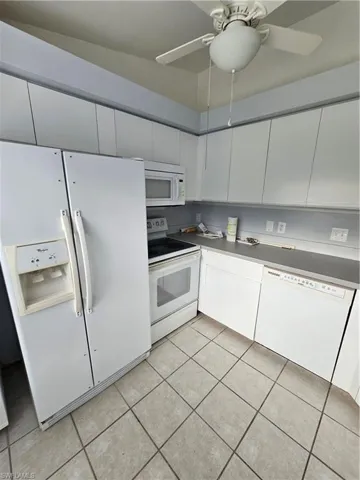 Kitchen with refrigerator, white cabinetry, dishwasher, white electric range oven, and ceiling fan
