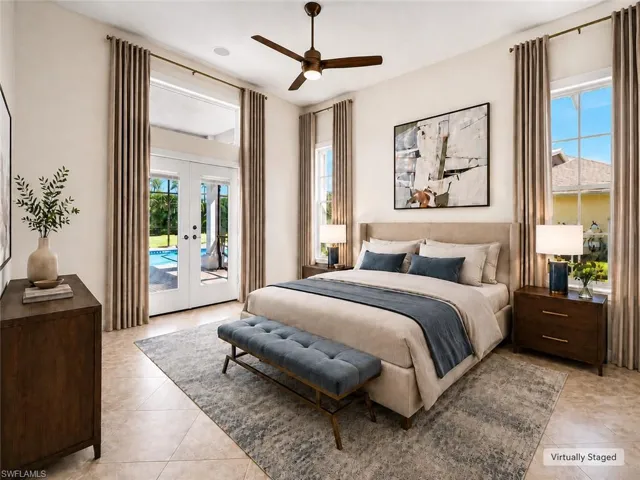Room featuring tiled flooring, a ceiling fan, and direct access to a patio with a swimming pool via French doors