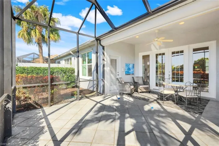 Sunroom / solarium with french doors and ceiling fan