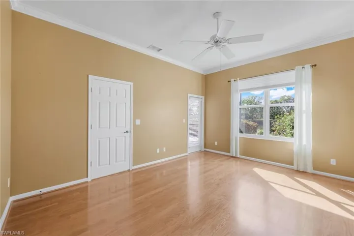 Unfurnished room with crown molding, ceiling fan, and light hardwood / wood-style floors