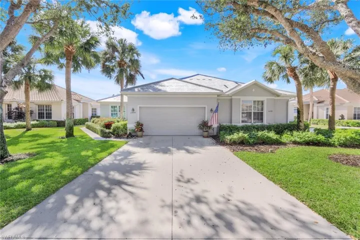Single story home with a garage and a front yard