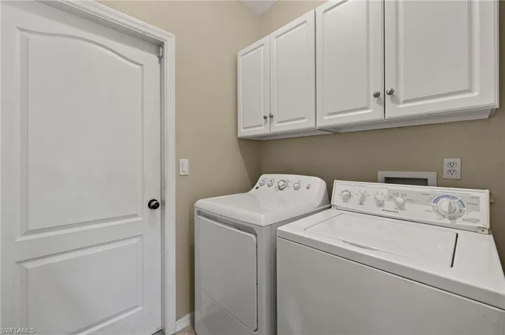 Laundry area with cabinet space and washing machine and dryer