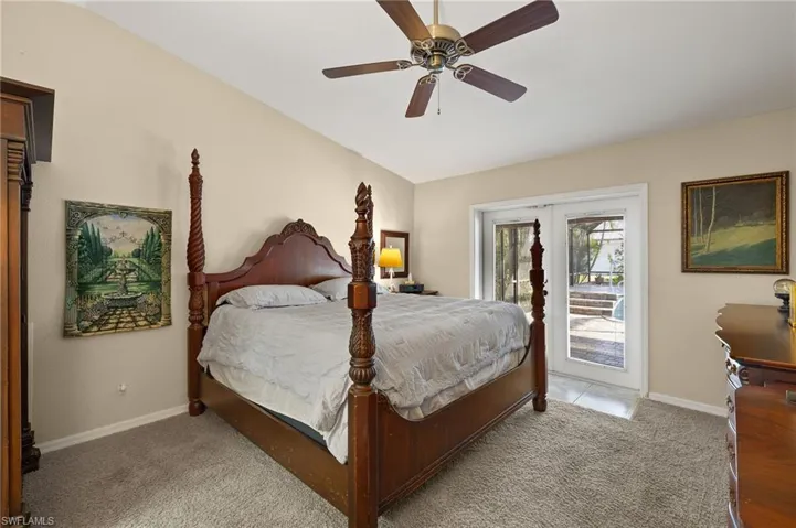 Bedroom featuring access to exterior, baseboards, and light colored carpet