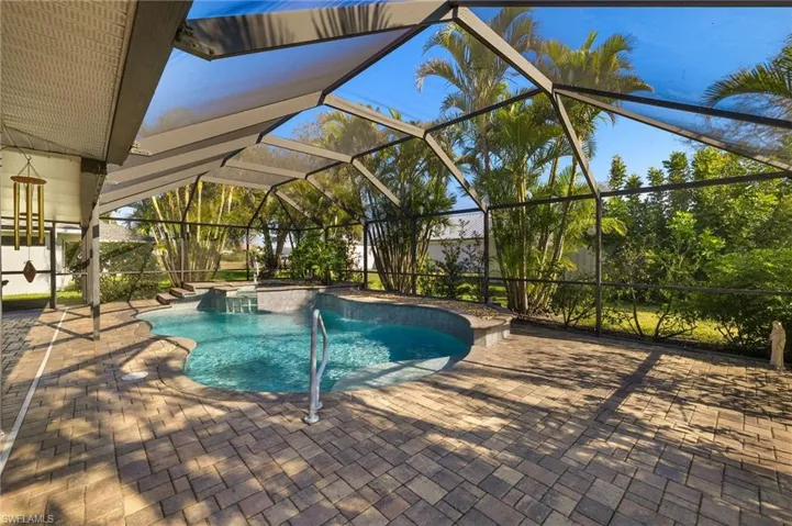 Outdoor pool featuring a lanai and a patio