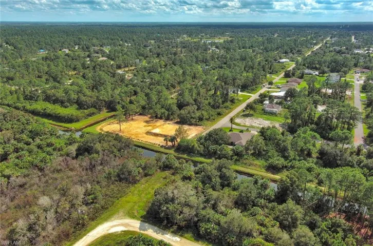 Bird's eye view of a nearby body of water and a heavily wooded area