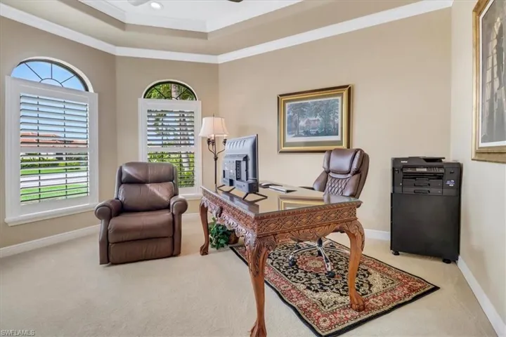 Office area with carpet and ornamental molding